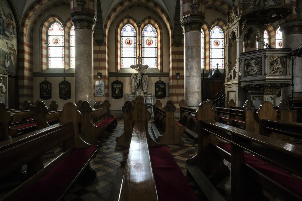 In this Thursday, April 9, 2020 photo the Sacred Heart Cathedral in Sarajevo, Bosnia, is deserted due to the national lockdown the authorities have imposed attempting to limit the spread of the new coronavirus. Sarajevo, a religious melting pot throughout its more than five-centuries-long history, would normally be teeming with life this April. Instead, along with the rest of Bosnia and most of the world, it is under a lockdown to try to bring the new coronavirus under control. (AP Photo/Kemal Softic)