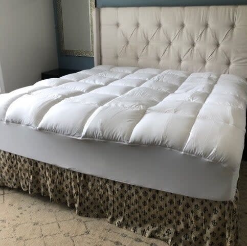 White mattress topper on bed