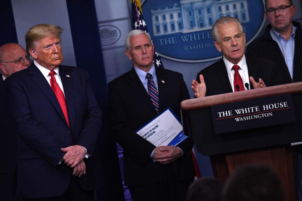 President Donald Trump and Vce President Mike Pence listen to Peter Navarro, coordinator of the Defense Production Act policy, at the coronavirus briefing on March 22, 2020.