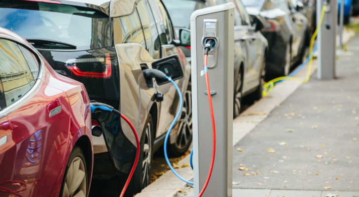 electric vehicles charging at a charging station. electric vehicle stocks