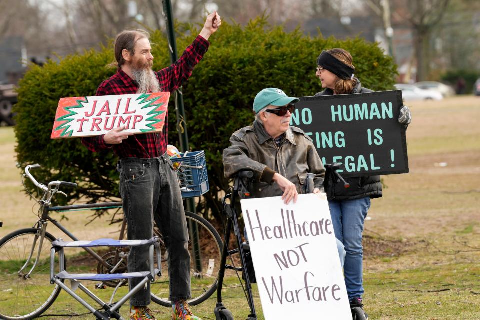 Pat Meany, of Hackensack, Jan Berry, of Teaneck, and Pat McPartland, of Bergenfield, hold signs outside of the Teaneck Armory. Wednesday, March 22, 2023