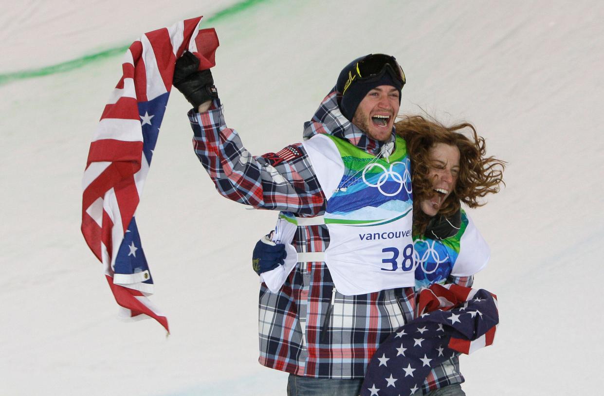 Olympic gold medal champion Shaun White, right, and bronze medalist Scotty Lago of the United States celebrate following the men's snowboard halfpipe competition at the 2010 Olympics in Vancouver, British Columbia, Wednesday, Feb. 17, 2010.