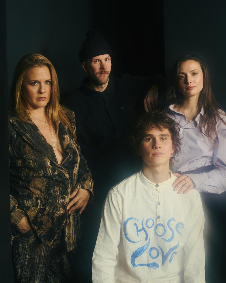 Four people pose for a portrait.