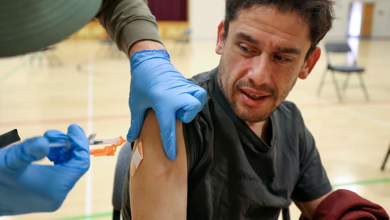 Jesus Hernandez gets a Moderna COVID-19 booster shot during a free vaccine clinic at the Sanderson Community Center in Taylorsville on Wednesday, Nov. 9, 2022. The Utah Department of Health and Human Services is set to stop reporting COVID-19 case counts next month.