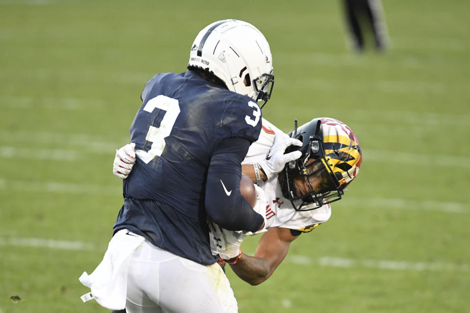 Maryland defensive back Tarheeb Still (12) tackles Penn State wide receiver Parker Washington (3) in the second quarter of an NCAA college football game in State College, Pa., Saturday, Nov. 7, 2020. (AP Photo/Barry Reeger)