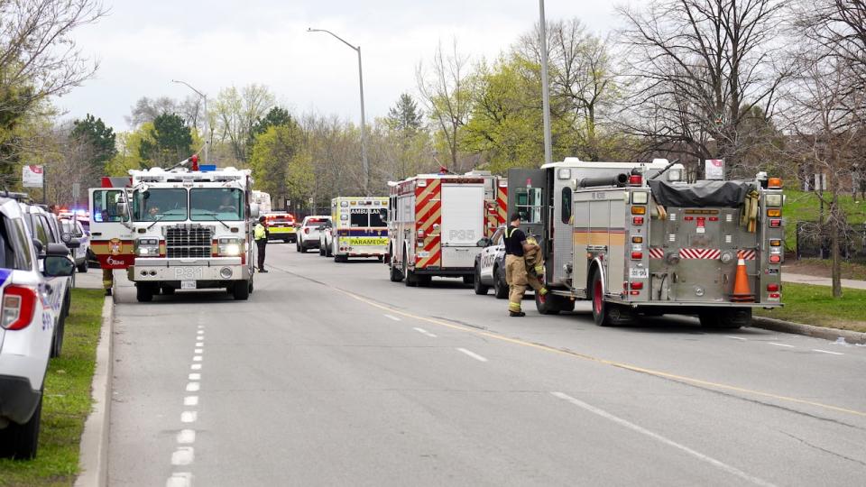 Emergency crews line Donald Street in Overbrook after a fire started on the third floor of a highrise building early Thursday morning.              