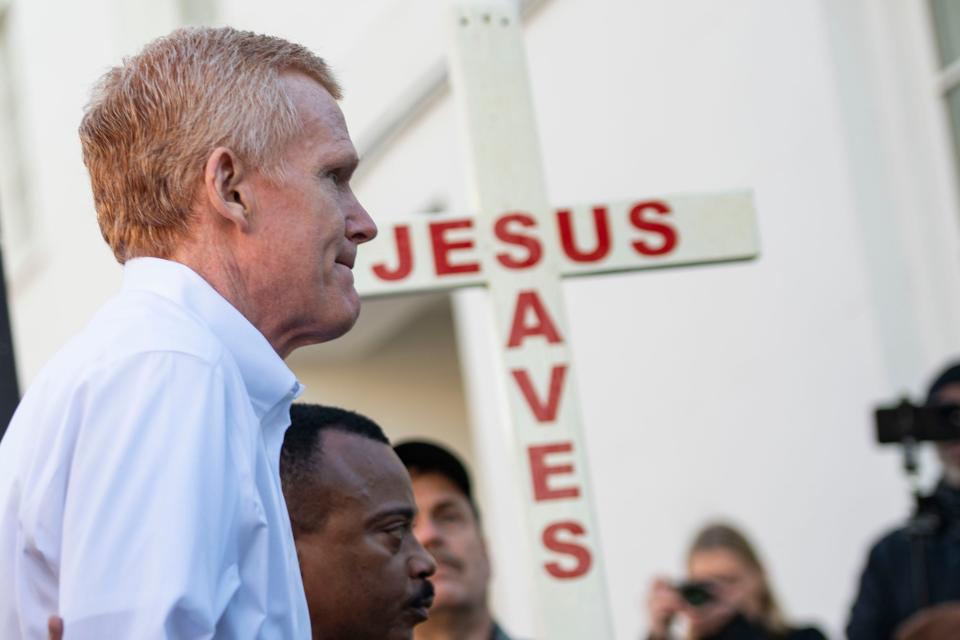  Stan Mitchell, from out of town, holds a Jesus saves cross as Alex Murdaugh arrives at the Colleton County Courthouse before day four of his double murder trail on Thursday, Jan. 26, 2023. 