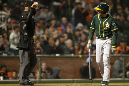 Jul 14, 2018; San Francisco, CA, USA; Oakland Athletics pinch hitter Jed Lowrie (right) reacts after being called out on strikes by umpire Vic Carapazza (left) during the ninth inning against the San Francisco Giants at AT&T Park. Mandatory Credit: D. Ross Cameron-USA TODAY Sports