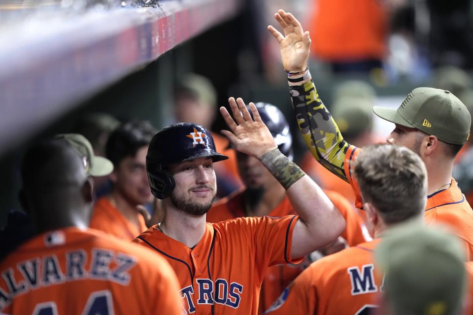 Houston Astros' Kyle Tucker celebrates in the dugout after hitting a two-run home run against the Oakland Athletics during the sixth inning of a baseball game Friday, May 19, 2023, in Houston. (AP Photo/David J. Phillip)