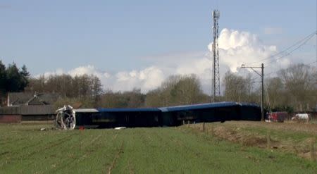 A derailed Dutch passenger train is seen in Dalfsen, Netherlands, in this still image from a video released February 23, 2016. REUTERS/NOS via Reuters TV