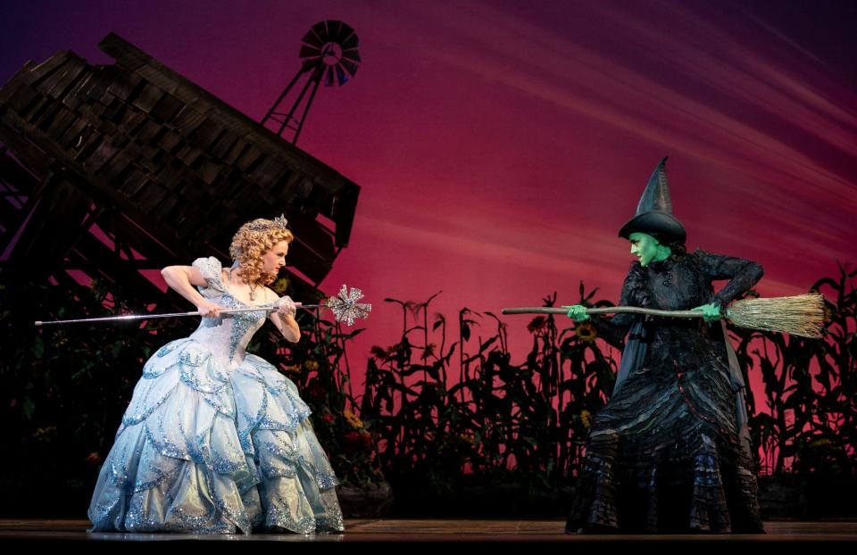 Jennafer Newberry as Glinda and Lissa DeGuzman as Elphaba square off in 'Wicked.'