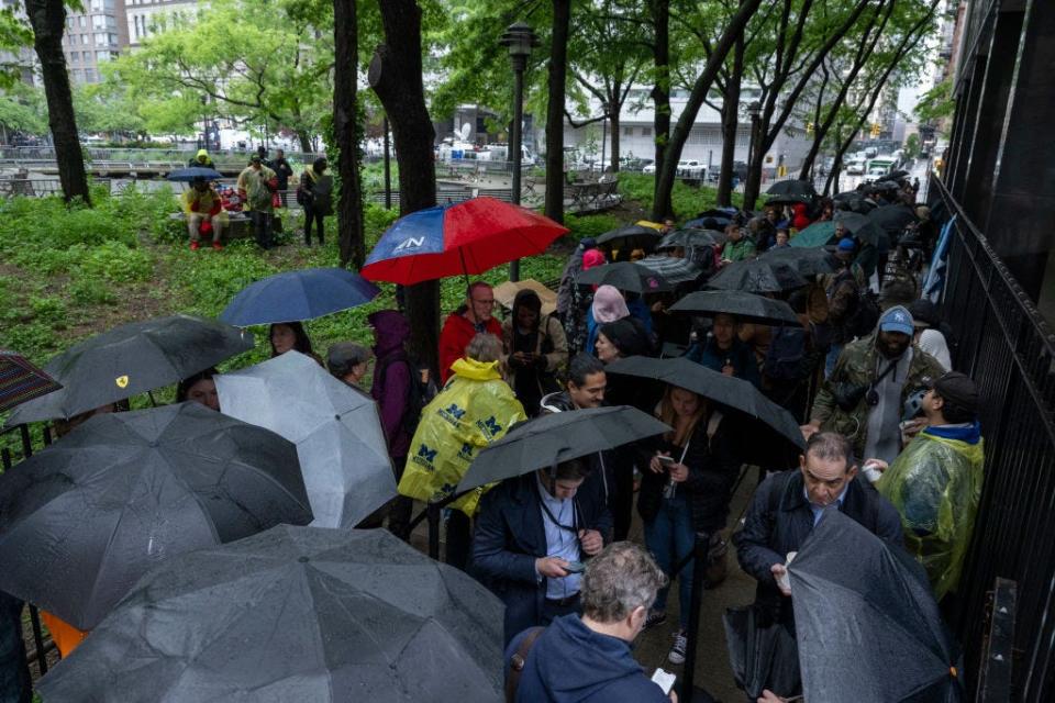 People line up to get inside the Manhattan Criminal Court for the trial of former US President Donald Trump charged with covering up hush money payments linked to extramarital affairs, in New York City, on May 16, 2024. Trump's defense team Thursday continues the questioning of Michael Cohen, the key witness in the criminal trial of the former president. (Photo by ANGELA WEISS / AFP) (Photo by ANGELA WEISS/AFP via Getty Images)