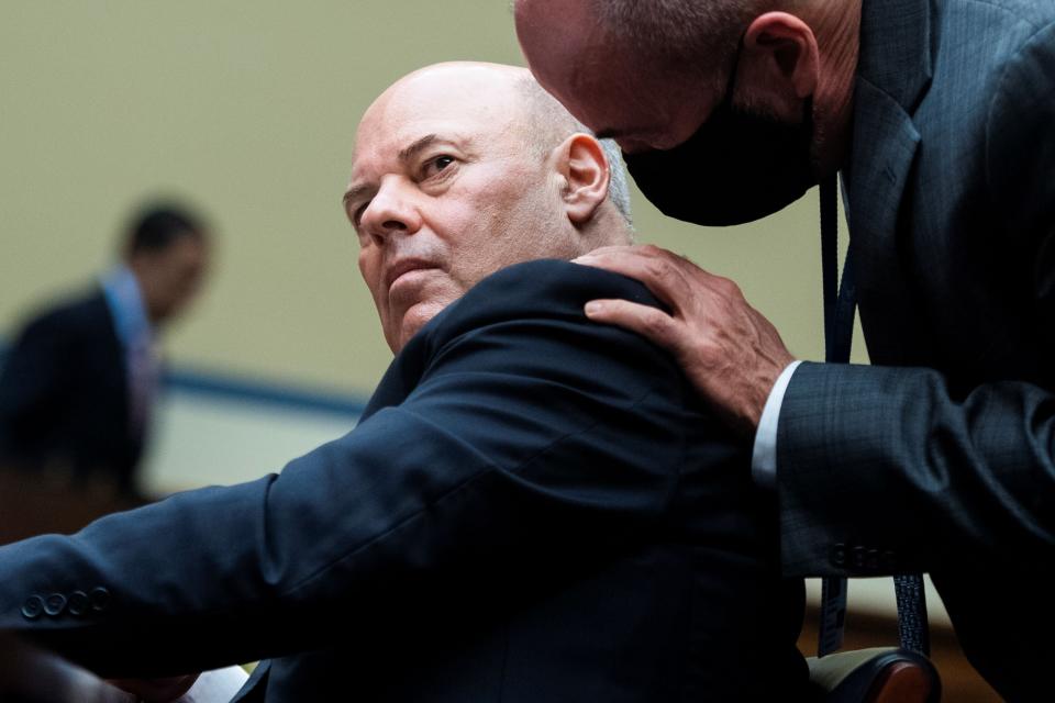 Postmaster General Louis DeJoy talks with an aide on Aug. 24 as he testifies before a House Oversight and Reform Committee hearing on slowdowns at the Postal Service ahead of the November election on Capitol Hill in Washington. (Photo: Tom Williams/POOL via Reuters)