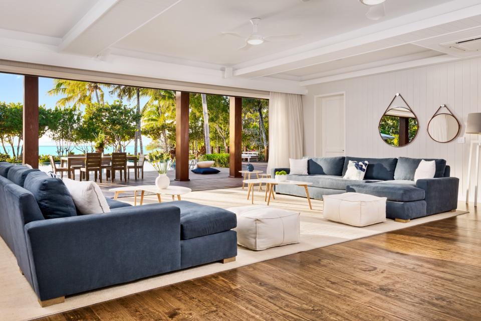 The beach and palm trees outside add color to the living room.