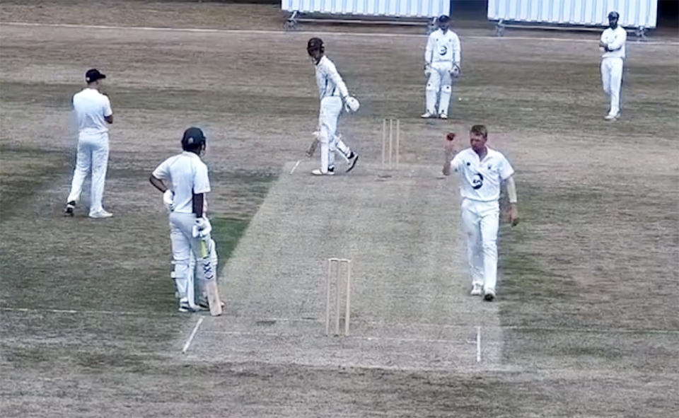 The bowler, pictured here throwing down the stumps at the non-striker's end while walking back to his mark.