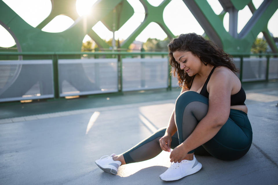 Woman tying her shoe