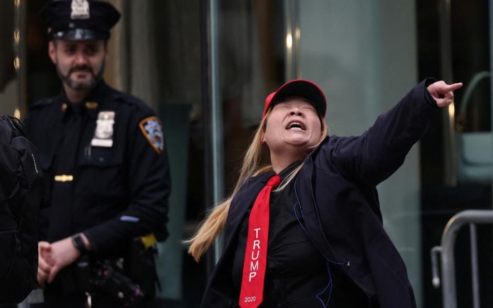 A Trump supporter screams outside Trump Tower before the former president departed to attend his criminal trial on Thursday