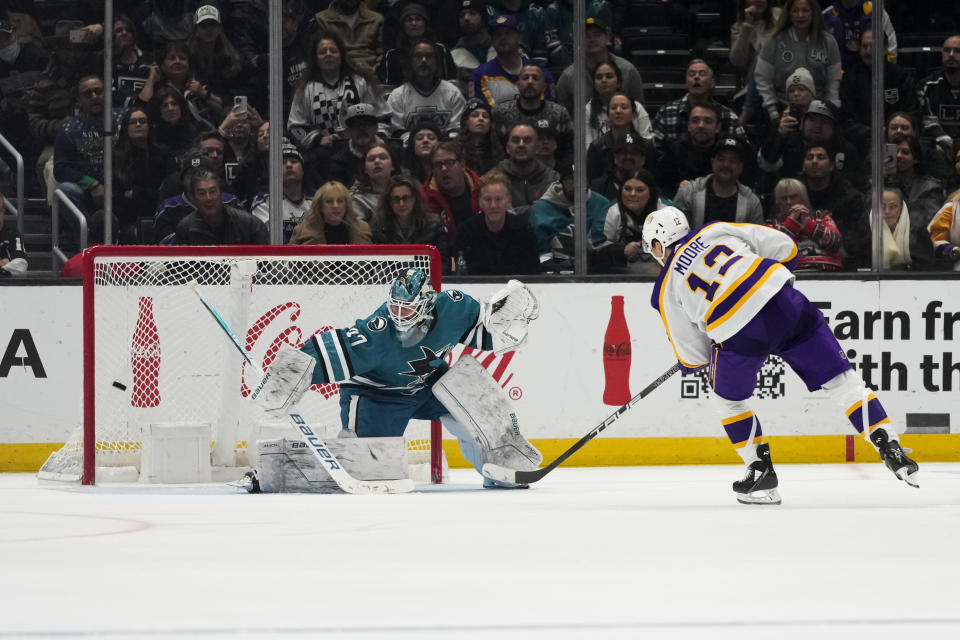 Los Angeles Kings' Trevor Moore (12) scores against San Jose Sharks goaltender James Reimer in a shootout of an NHL hockey game Saturday, Dec. 17, 2022, in Los Angeles. The Kings won 3-2. (AP Photo/Jae C. Hong)