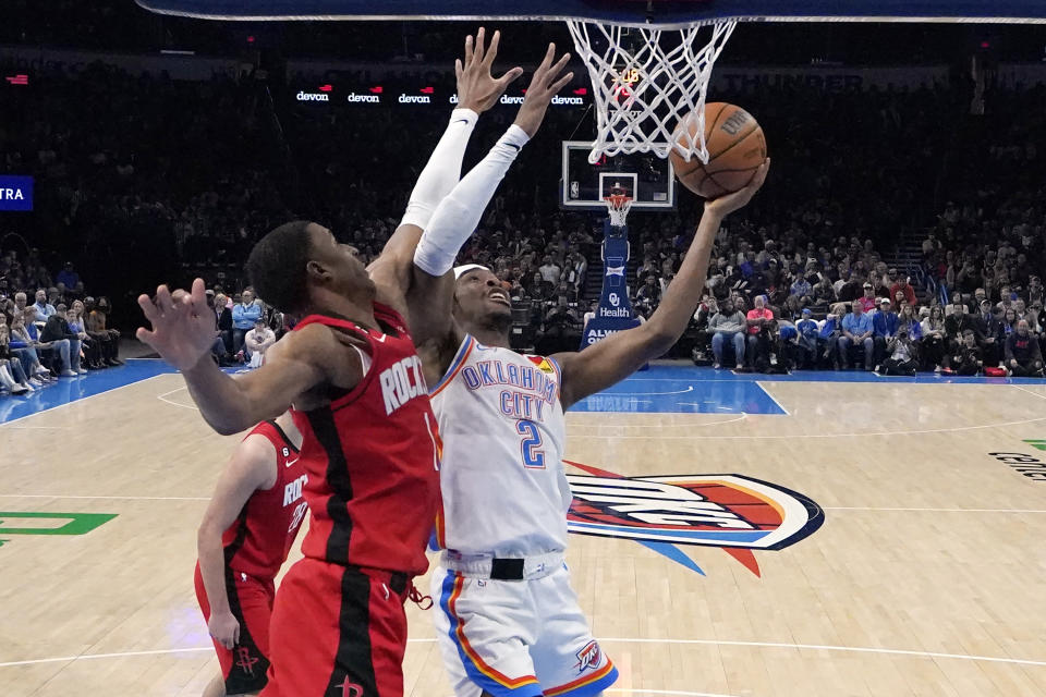 Oklahoma City Thunder guard Shai Gilgeous-Alexander (2) shoots in front of Houston Rockets forward Jabari Smith Jr. (1) in the first half of an NBA basketball game Saturday, Feb. 4, 2023, in Oklahoma City. (AP Photo/Sue Ogrocki)