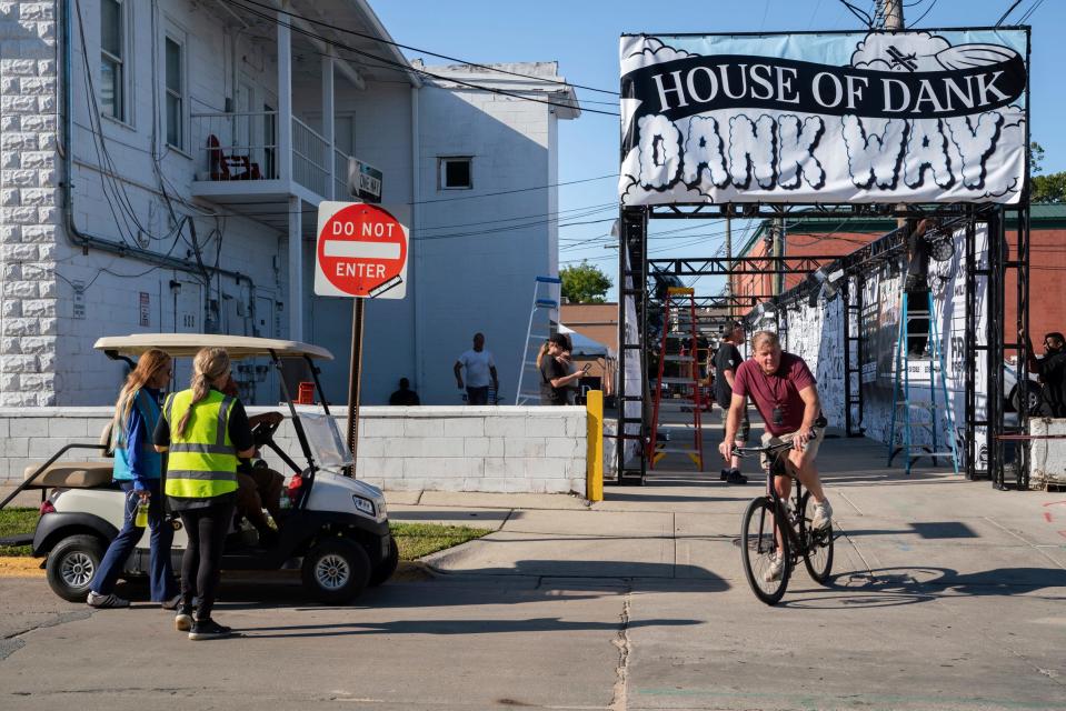 Jon Witz, 61, producer of the Soaring Eagle Arts Beats & Eats festival, rides his bike near the festival's first designated cannabis space in Royal Oak on Thursday, Aug. 31, 2023.