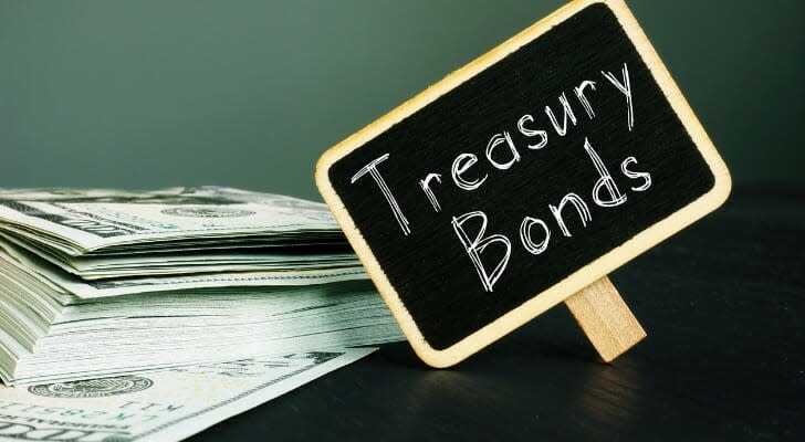 Cash and a chalk board that says "Treasury Bond" on it