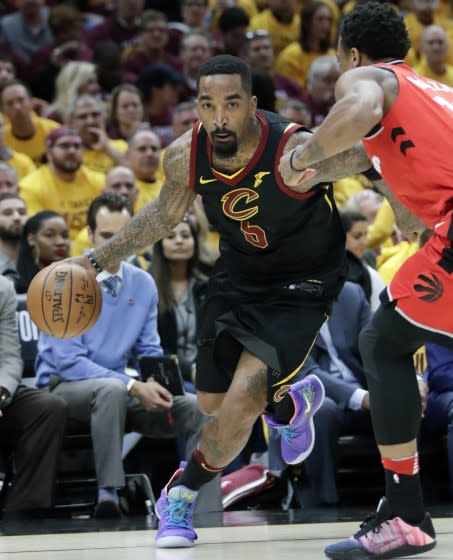 FILE - In this May 7, 2018, file photo, Cleveland Cavaliers' J.R. Smith (5) drives on Toronto Raptors' DeMar DeRozan in the first half of Game 4 of an NBA basketball second-round playoff series, in Cleveland. Smith's never-a-dull-moment run with the Cavaliers is over. Cleveland released the colorful shooting guard Monday, July 15, 2019, before his $15.6 million contract for next season became guaranteed. The Cavs had been trying to trade Smith for months, but the team was unable to find the right deal even after he agreed to extend his guarantee date from June 30 to July 15. (AP Photo/Tony Dejak, File)