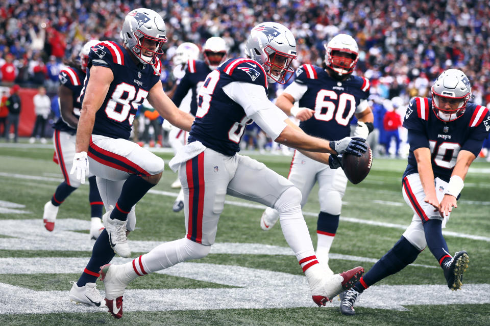 New England Patriots tight end Mike Gesicki, center, celebrates with teammates after his touchdown against the Buffalo Bills during the second half of an NFL football game, Sunday, Oct. 22, 2023, in Foxborough, Mass. (AP Photo/Michael Dwyer)