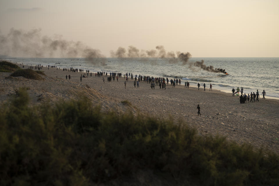 Palestinian protesters walk along the beach near the border with Israel in Beit Lahiya, northern Gaza Strip, Sunday, Sept. 2, 2018. (AP Photo/Felipe Dana)