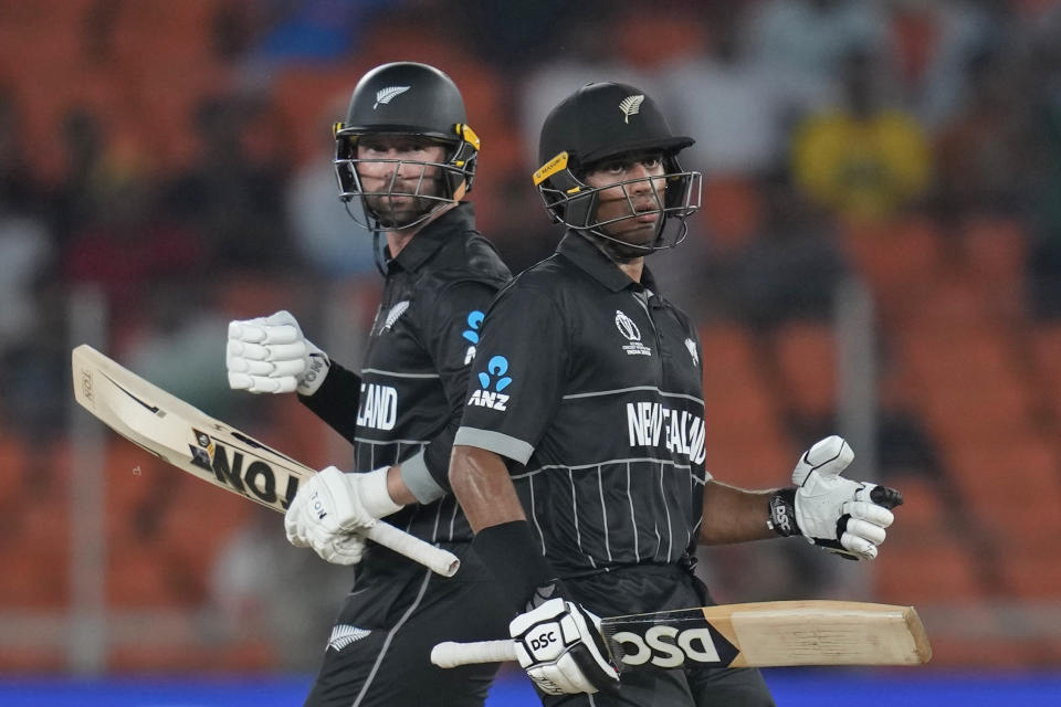 New Zealand's Rachin Ravindra and Devon Conway, left, run between the wickets bats during the ICC Cricket World Cup opening match between England and New Zealand in Ahmedabad, India, Thursday, Oct. 5, 2023. (AP Photo/Rafiq Maqbool)