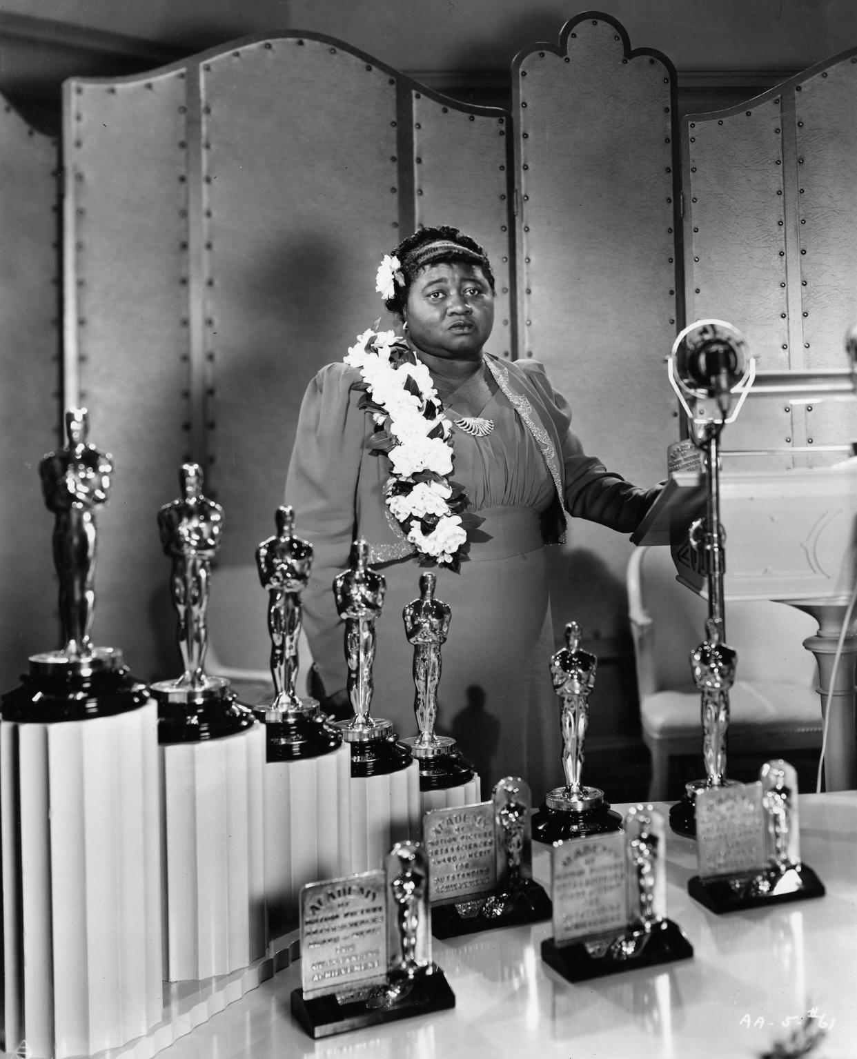 Portrait of Hattie McDaniel at the 12th Academy Awards ceremony on Feb. 29, 1940. McDaniel made history that night when she became the first Black performer to win an Oscar. Examples of what her Oscar plaque would have looked like sit in the foreground.