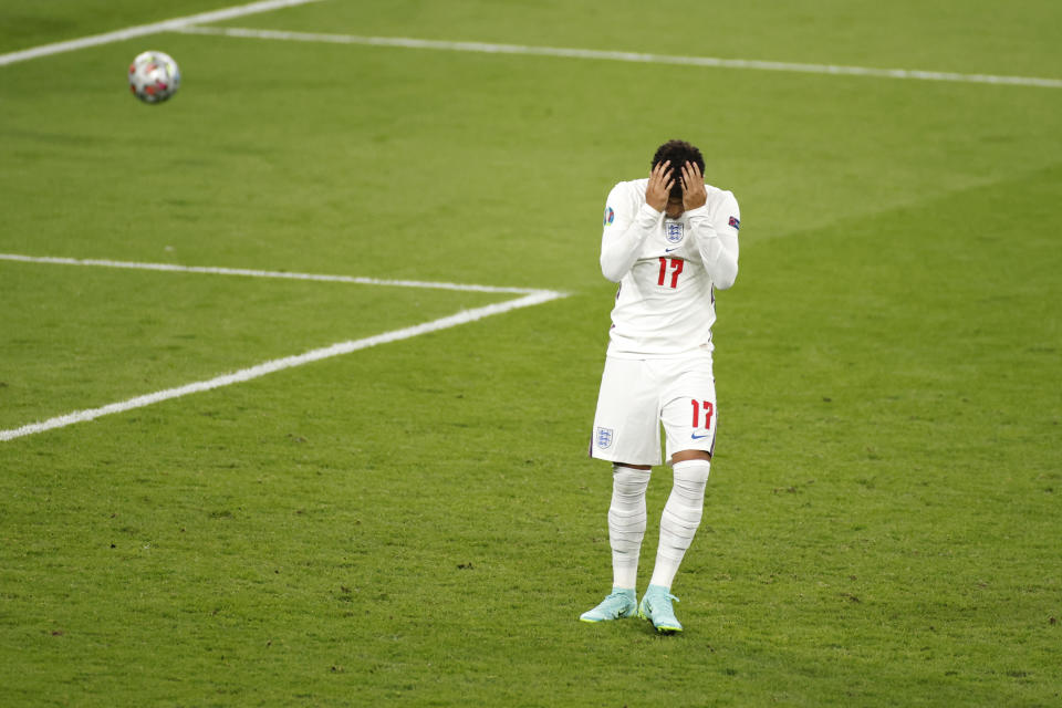 FILE - England's Jadon Sancho reacts after missing his shot at goal during a penalty shootout at the Euro 2020 soccer championship final between England and Italy at Wembley stadium in London, Sunday, July 11, 2021. Black players like Marcus Rashford and Bukayo Saka have flourished even after being targeted online for missing penalties in England's shootout loss to Italy in the European Championship final in 2020. But a third Black player who also missed a penalty and was racially abused, Jadon Sancho, has struggled on the field ever since. (John Sibley/Pool Photo via AP, File)