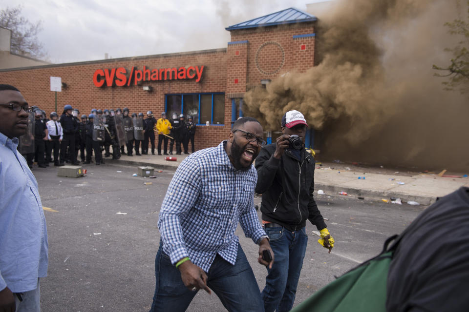 BALTIMORE, MD - APRIL 27: A protestor yells as a CVS burns near West North Avenue and Pennsylvania Avenue during a protest for Freddie Gray in Baltimore, MD on Monday April 27, 2015. Gray died from spinal injuries about a week after he was arrested and transported in a police van. (Photo by Jabin Botsford/The Washington Post via Getty Images)