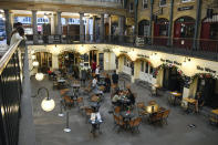 FILE - In this Sept. 22, 2020 file photo, people are seated eating and drinking in Covent Garden, in London. The coronavirus pandemic is gathering strength again in Europe and, with winter coming, its restaurant industry is struggling. The spring lockdowns were already devastating for many, and now a new set restrictions is dealing a second blow. Some governments have ordered restaurants closed; others have imposed restrictions curtailing how they operate. (AP Photo/Alberto Pezzali, File)