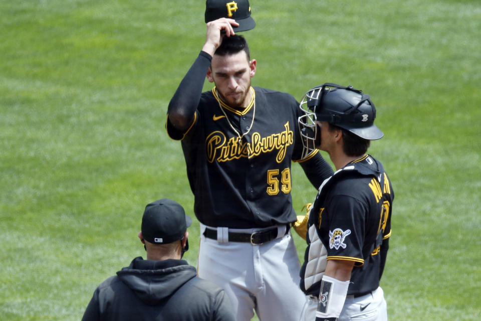 Pittsburgh Pirates pitcher Joe Musgrove, center, gets a mound visit in the first inning of a baseball game against the Minnesota Twins, Tuesday, Aug. 4, 2020, in Minneapolis. Musgrove gave up three runs in the inning. (AP Photo/Jim Mone)