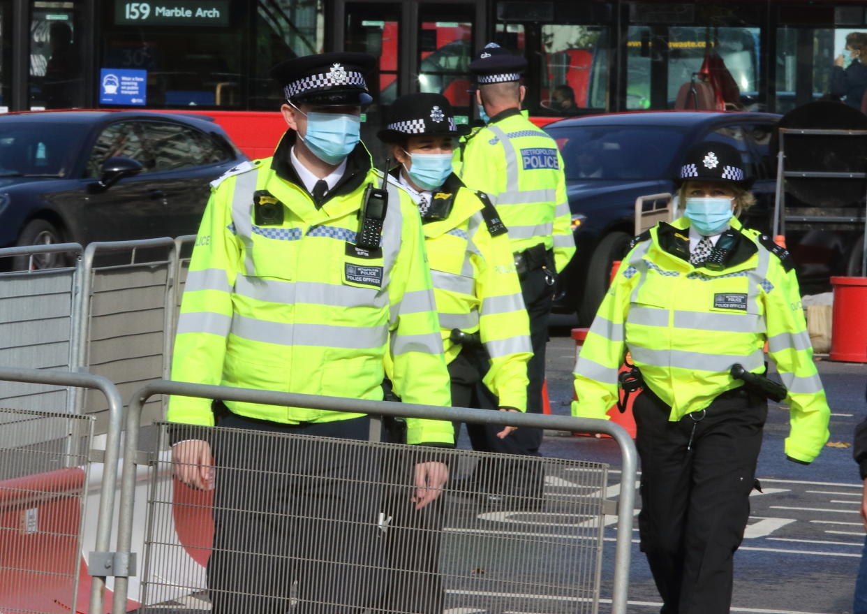  Policemen are seen wearing facemasks around Parliament Square. Public people are seen wearing facemasks while out shopping in London following prime minister, Boris Johnson's announcement of a new three tier lockdown system because of the increasing cases of coronavirus infections in the UK. (Photo by Keith Mayhew / SOPA Images/Sipa USA) 