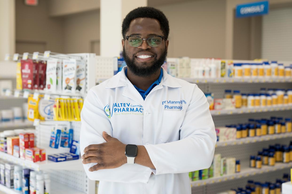 Pharmacist and owner Emmanuel "Manny" Ayanjoke stands on the sales floor of Altev Community Pharmacy in Avondale.