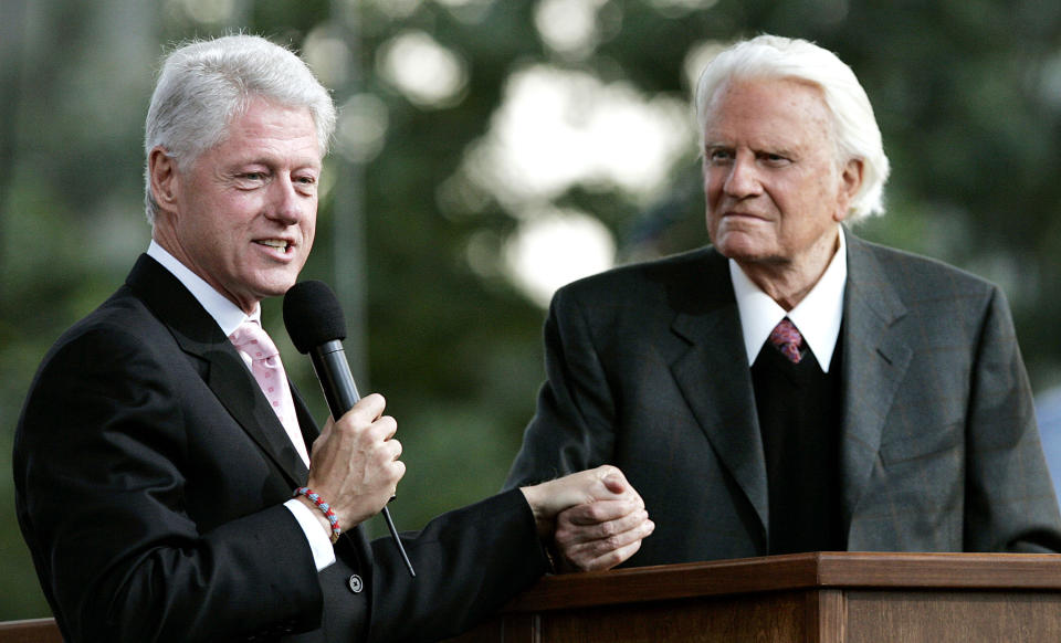 NEW YORK - JUNE 25:  Former U.S. President Bill Clinton speaks along with Billy Graham during Graham's Crusade at Flushing Meadows Corona Park June 25, 2005 in the Queens borough of New York. Flushing Meadows Corona Park is the site for Graham's sermons on June 24-26, which looks to draw thousands of people from across the country, and will purportedly be the aging Christian evangelist's final crusade. (Photo by Stephen Chernin/Getty Images)