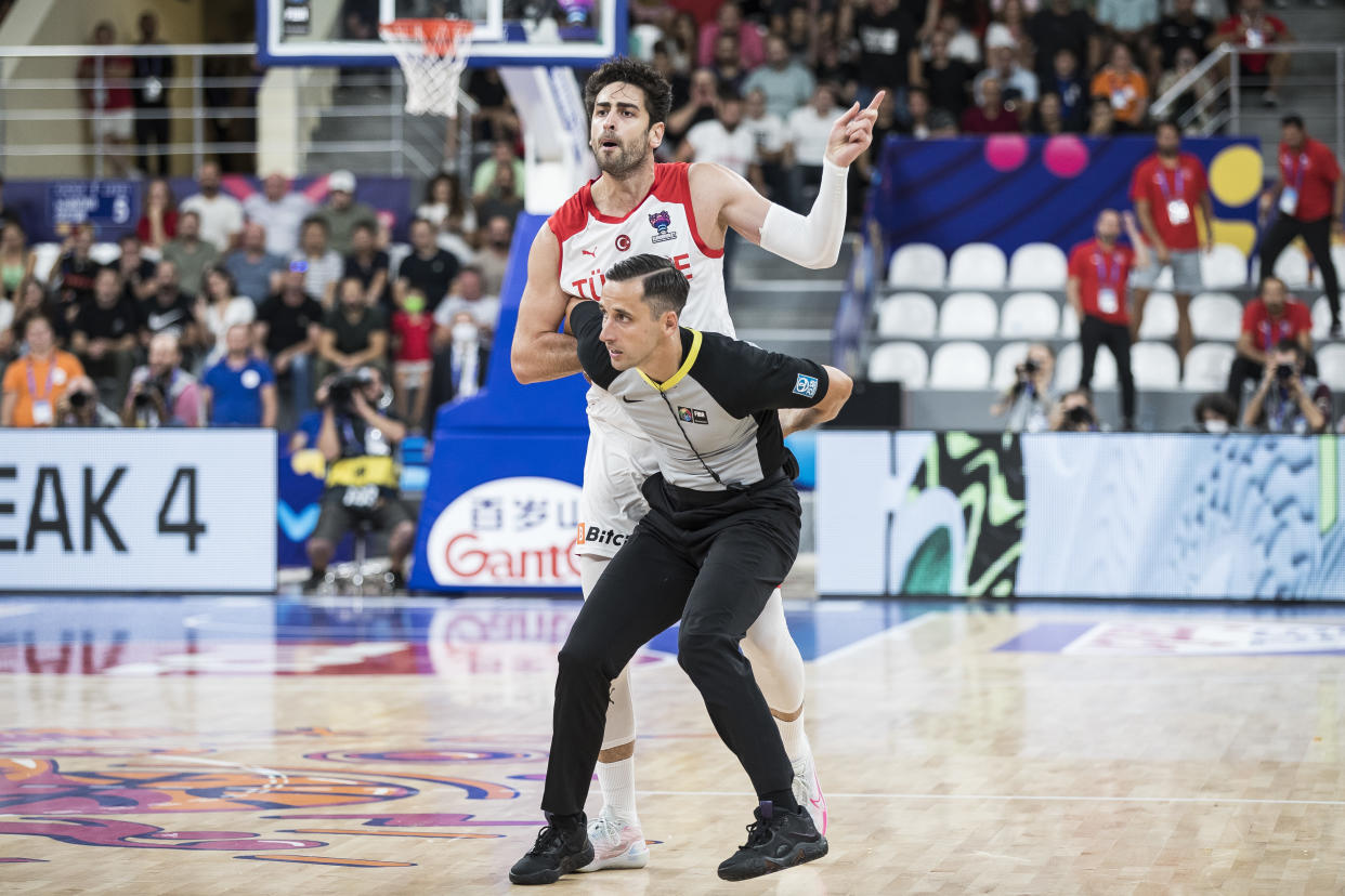 The referee protect Furkan Korkmaz of Turkey