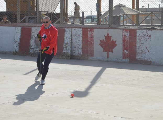 Ambassador Ken Neufeld takes part in the final ball hockey game at the Canadians' rink at Kandahar Airfield. Photo courtesy Global Affairs Canada.
