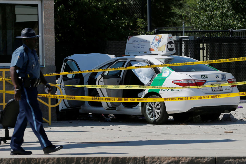 <p>A Massachusetts State Police officer walks past the scene where a taxi cab crashed into a group of bystanders at the taxi pool at Logan International Airport in Boston, Massachusetts, U.S., July 3, 2017. (Brian Snyder/Reuters) </p>