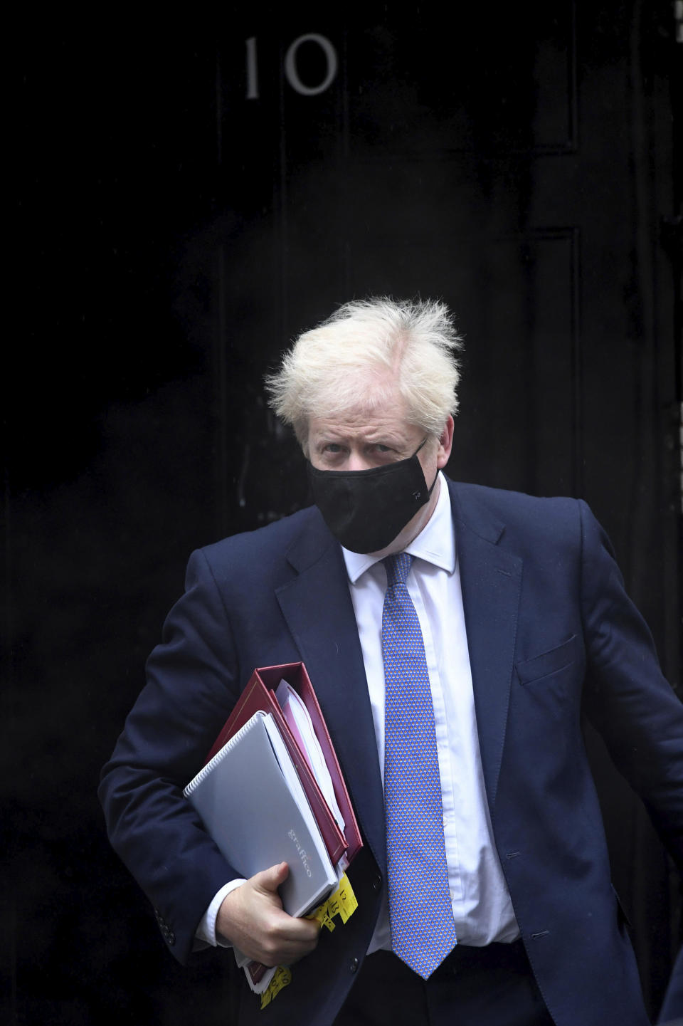 Britain's Prime Minister Boris Johnson leaves 10 Downing Street to attend the parliament Prime Minister's Questions, at the Houses of Parliament in London, Wednesday Oct. 21, 2020. The government imposed highly restrictive Tier 3 restrictions on the northern England region of Greater Manchester on Tuesday after failing to reach agreement with local authorities. (Stefan Rousseau/PA via AP)