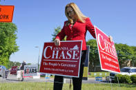 Republican gubernatorial candidate State Sen. Amanda Chase, places a yard sign during a drive through GOP Convention vote in Chesterfield, Va., Saturday, May 8, 2021. (AP Photo/Steve Helber)