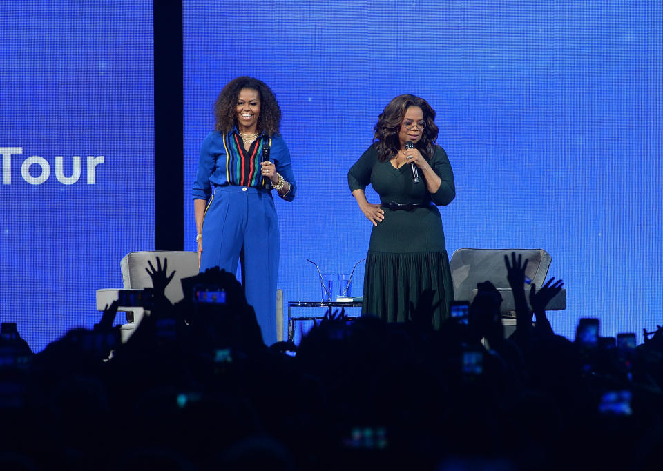 Michelle Obama, left, and Oprah Winfrey speak onstage at "Oprah's 2020 Vision: Your Life in Focus" tour at the Barclays Center on Saturday, Feb. 8, 2020, in New York. (Photo by Brad Barket/Invision/AP)