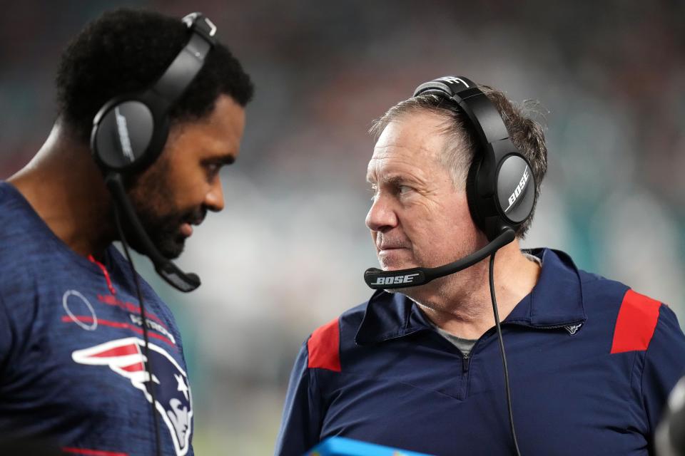 MIAMI GARDENS, FLORIDA - JANUARY 09: Head coach Bill Belichick of the New England Patriots and inside linebackers coach Jerod Mayo talk on the sidelines in the fourth quarter of the game against the Miami Dolphins at Hard Rock Stadium on January 09, 2022 in Miami Gardens, Florida. (Photo by Mark Brown/Getty Images)