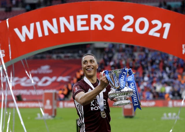 Youri Tielemans celebrates with the trophy 