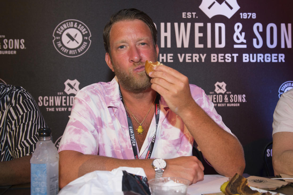 Dave Portnoy eats a hamburger at Burger Bash in Miami Beach.