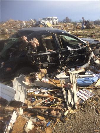 Extensive damage to homes and vehicles is pictured in the aftermath of tornado that touched down in Washington, Illinois