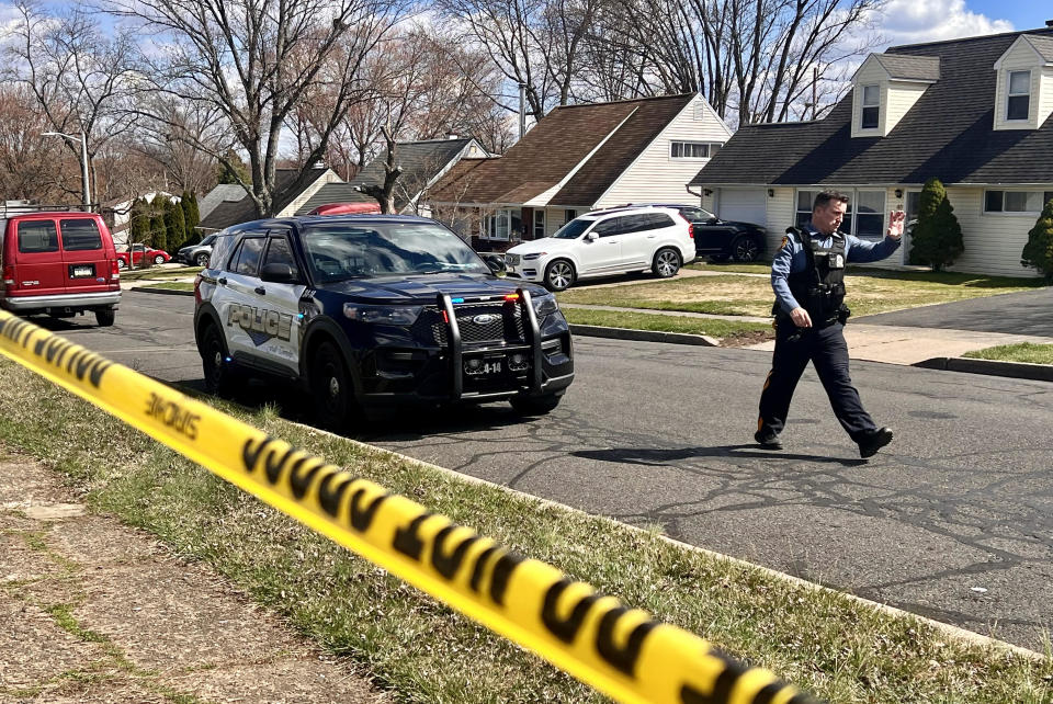 A police officer patrols a neighborhood during an active shooter situation in Levittown, a community within Falls Township, Pennsylvania, where a shelter-in-place order was issued on March 16, 2024.  / Credit: JOE LAMBERTI/AFP via Getty Images