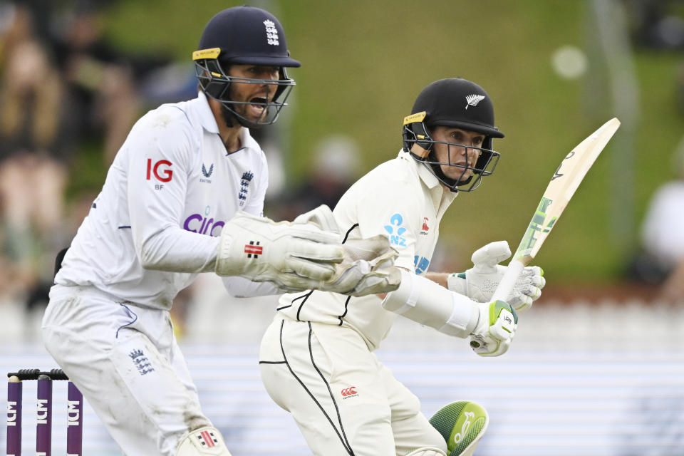 Tom Latham, right, of New Zealand bats as England wicketkeeper Ben Foakes looks on during play on day three of the second cricket test between England and New Zealand at the Basin Reserve in Wellington, New Zealand, Sunday, Feb. 26, 2023. (Andrew Cornaga/Photosport via AP)