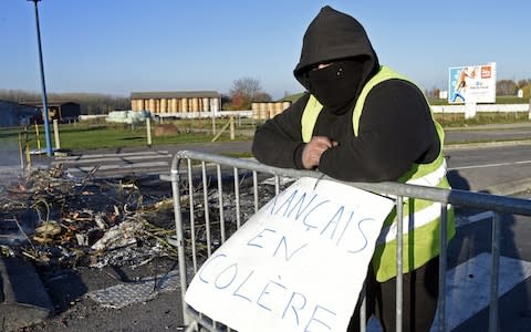 A demonstrator stands by a sign reading "Angry French" - Credit: FRANCOIS LO PRESTI/AFP/Getty Images